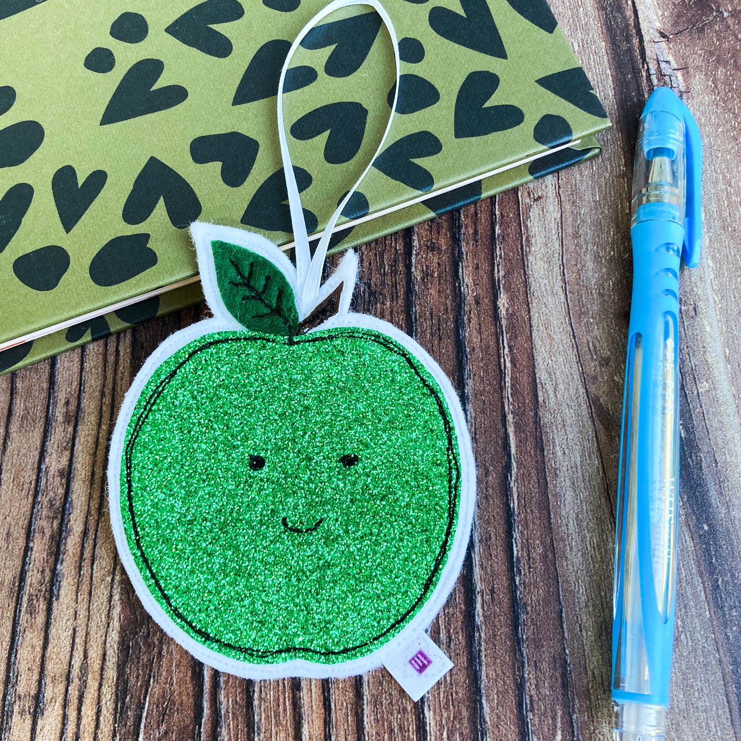 Green Glittery Apple Decoration with a notebook and pen