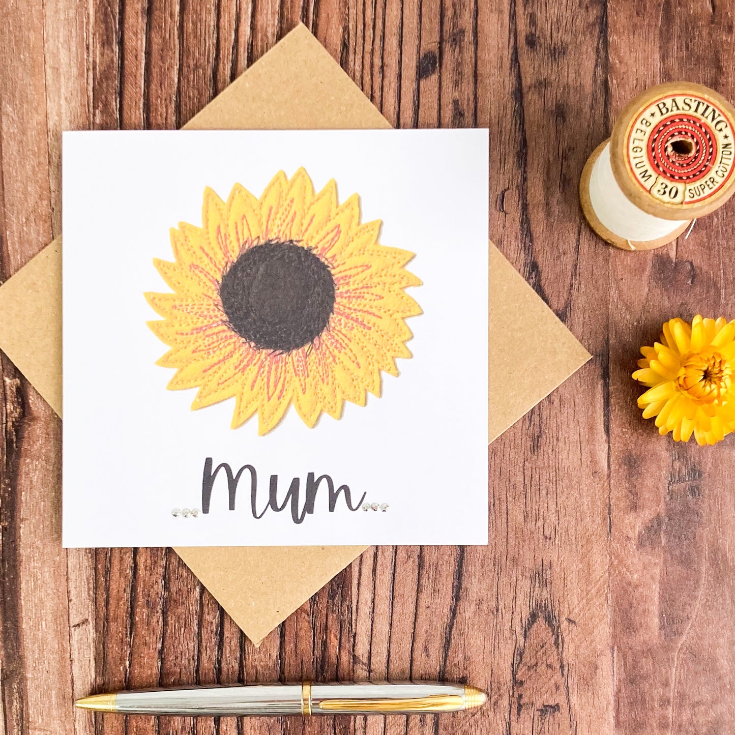 Sunflower Printed Greetings Card with the word Mum and 6 diamante, plus one brown envelope, a pen, dried flower and basting thread