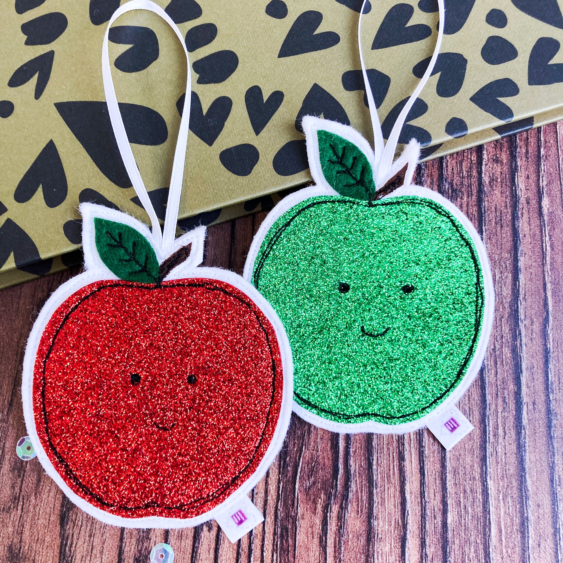 Red and Green Glittery Decorations placed on a noteook